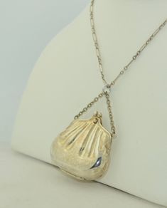 This is a.cute oversized purse or handbag pendant. It is crafted from sterling silver and hallmarked. The form is a puffy three dimensional old fashion hand bag. The purse is hollow and does not open. It features a chain handle of which I have placed a sterling silver jump ring. This pendant looks fabulous on a short chain (not included). The condition is excellent with minimal wear and minimal patina. Measurements: Length: 2 1/4 inches (57 mm) Width: 1 1/2 Inches (40.6 mm) Depth: 15 mm (a littl Vintage Silver Necklace For Everyday, Silver Vintage Necklace For Everyday, Compact Silver Jewelry For Formal Occasions, Elegant Silver Necklace For Everyday Use, Formal Silver Engraved Bags, Vintage Engraved Bags As Gifts, Victorian Silver Bag For Gift, Nickel-free Oval Pendant Jewelry For Keepsake, Luxury Silver Tarnish-resistant Coin Necklace