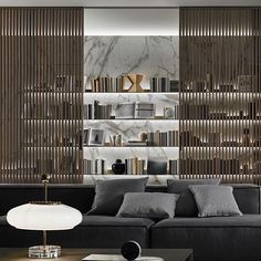 a living room filled with furniture and bookshelves next to a wall mounted book shelf