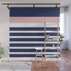 a living room with blue, pink and white stripes on the wall next to a ladder