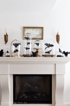 a mantle with candles and bats on it