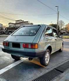 an old car is parked on the side of the road