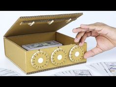 a cardboard box that has money in it and is being held by someone's hand