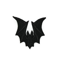 a black bat shaped patch on a white background