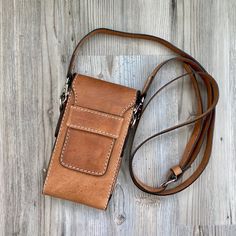 a brown leather bag sitting on top of a wooden floor