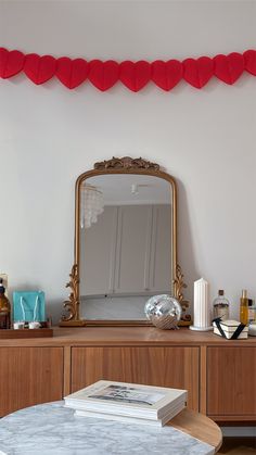 a table with a mirror and some books on it