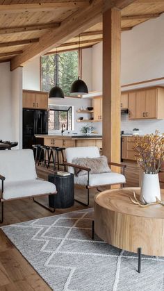 a living room filled with furniture next to a kitchen