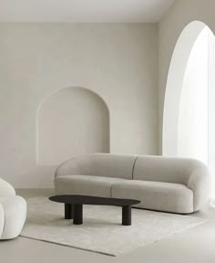 a living room with two white couches and a coffee table in the middle of it