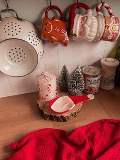 the kitchen counter is cluttered with dishes and utensils for christmas decorating