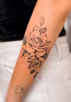 a woman's arm with a rose tattoo on it