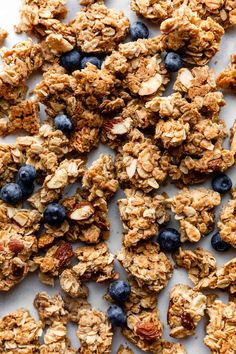 granola with blueberries and almonds on a white surface