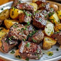 steak and potatoes on a plate with parsley sprinkled on the side, ready to be eaten