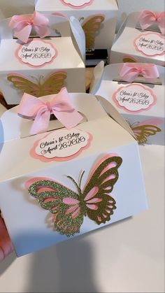 several boxes with pink and gold butterflies on them