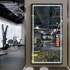 an indoor gym with mirrors and exercise equipment