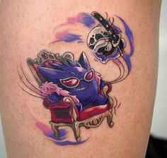 a tattoo on the leg of a woman with a cat sitting in a chair next to a clock