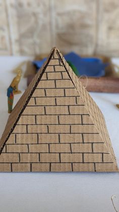 a paper model of a pyramid on a table