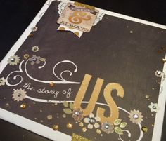 a close up of a piece of paper with gold glitters and flowers on it