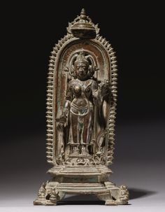 an ornately carved statue with a woman on it's chest and head in the center