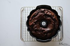 a chocolate cake sitting on top of a cooling rack