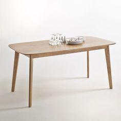 a wooden table with glasses on it and a plate sitting on top of the table