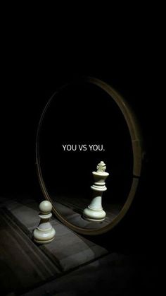 a mirror with chess pieces in it and the words you vs you written on it