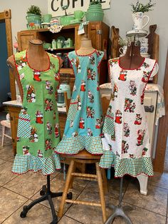 three mannequins dressed in aprons are on display at a craft shop