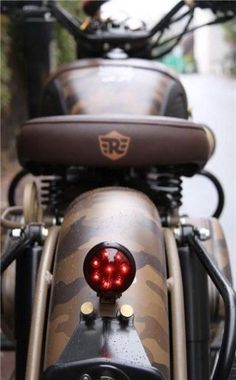 a close up of a motorcycle with a red light on it's handlebars