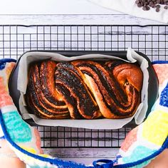 a loaf of cinnamon swirl bread sitting on top of a table next to some chocolate chips