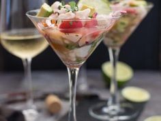 two martini glasses filled with fruit and veggies