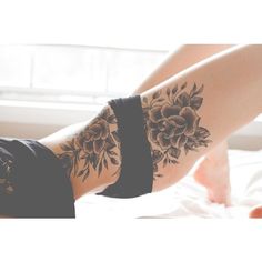 a woman's legs with flowers on them and her leg in the shape of a flower