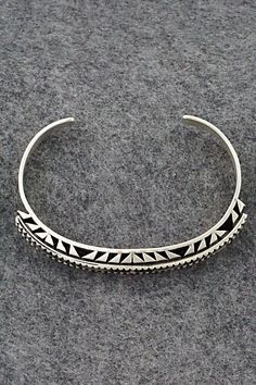 This sterling silver bracelet was made by Navajo silversmith Leander Tahe. The inside is signed L. Tahe and stamped sterling.Size: 5 3/4" (will fit up to a 7 1/8" wrist)Gap: 1 3/8"Width: 3/8"Free shipping on all orders! We ship with USPS and always include tracking. All orders ship within a day of payment.Returns are accepted up to 30 days after you receive your order. Just send us a message. Our shop offers cash back or store credit. The item must be returned in new condition. Sterling Silver Inlay Bracelets In Silver Color, Silver Bohemian Cuff Bracelet With Inlay, Bohemian Silver Cuff Bracelet With Inlay, Silver Bohemian Bracelets With Inlay, Sterling Silver Bracelet, Native American Jewelry, Free Jewelry, Sterling Silver Bracelets, Silver Bracelet