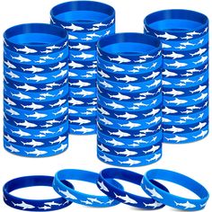 a bunch of blue and white bracelets with sharks on them