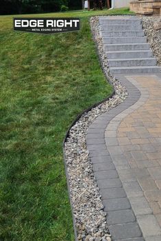 a man riding a skateboard down the side of a stone walkway in front of a house