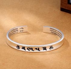 "Featuring the Six True Words Engraving Sterling silver Blessing Protection Bracelet. The Buddhist Heart Sutra is a beautifully carved on the inside of the bracelet and meant to bring love and compassion. The bangle is adjustable to your wrist size. These Six True Words 'Om Mani Padme Hum-are the most common mantra in Tibet. This mantra produces the sound and vibration which allows you to feel at one with the universe. The mantra is considered to have high spiritual and creative power. 0m means Tibetan Mantra, Bracelet For Him, Heart Sutra, Om Mantra, Om Yoga, Buddha Bracelets, Open Cuff Bracelet, Letter Bracelet, Silver Collection