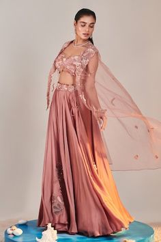 Pink sheer cape with sequin embroidered floral patterns. Comes with padded embroidered applique blouse, can can attached lehenga skirt and cut-out belt. - Aza Fashions Embroidered Fitted Sets With Cape Sleeves, Bollywood Style Pink Lehenga With Cape Sleeves, Festive Pink Choli With Cape Sleeves, Fitted Lehenga With Cutdana And Cape Sleeves, Cutdana Lehenga With Cape Sleeves, Pink Lehenga With Cape Sleeves, Applique Blouse, Sequin Cape, Cape Lehenga