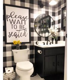 a white toilet sitting next to a black and white checkerboard wall in a bathroom