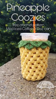 a cup filled with macaroni and cheese sitting on top of a stone wall