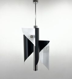 a black and white chandelier hanging from a metal pole with two lights on each side