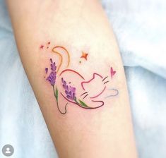 a cat tattoo on the arm with lavenders and stars around its neck is shown