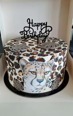 a birthday cake decorated with an image of a cheetah