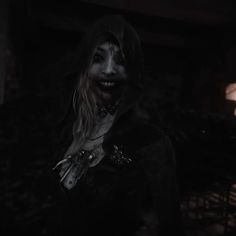 a creepy woman with makeup on her face in the dark