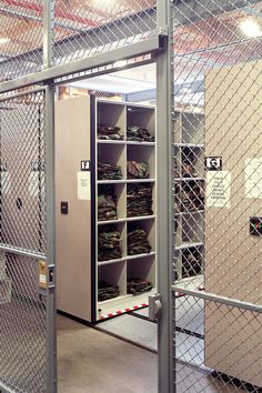 the inside of a storage room with lots of boxes and shelves on each side of the door