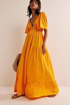 Forever free and flowy, this effortless maxi dress from our free-est collection is featured in a V-neck, tiered silhouette with flutter sleeves for added shape. * Soft, textured fabrication * Elastic empire waist * Effortless, pull-on style | La La Maxi Dress by free-est at Free People in Orange, Size: XS Empire Waist Summer Dresses, Destination Wedding Guest Dress, Bright Maxi Dress, Long Flowy Dress, Floor Length Maxi Dress, Flowy Summer Dresses, Orange Maxi Dress, Empire Dress, Tiered Maxi Dress