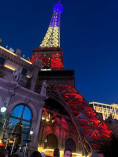 the eiffel tower lit up in red, white and blue