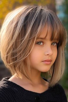 Opt for a sophisticated choice with an angled bob enriched by subtle highlights. The angled cut adds a twist to the classic bob haircut, while the subtle highlights bring depth and dimension to your hair. Click here to check out more adorable short hairstyles for little girls. Short Toddler Girl Haircut, Short Girl Haircuts For Kids, Girls Haircut Short, Short Hair For Girls Kids, Girl Haircut Kids, Girls Bob Haircut Kids, Girls Haircut Kids, Girls Short Haircut Kids, Girl Haircut Ideas