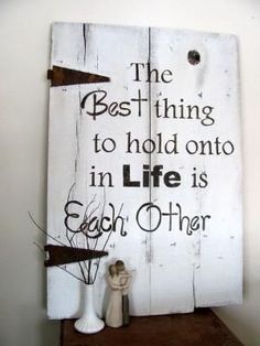 a wooden sign with the words, the best thing to hold onto in life is each other