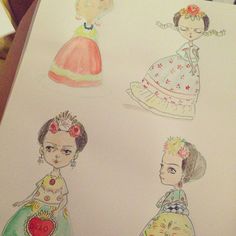 three drawings of children's dresses are shown on a piece of paper with colored pencils