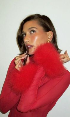 a woman in a red dress is brushing her teeth