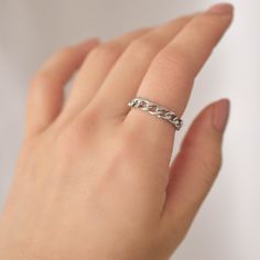 A simple silver ring featuring a chain design. This ring is collapsible so it will conform to your finger and is very comfortable to wear daily. Made of surgical steel, which features a deep, true silver color, this piece of jewelry is hypoallergenic, water-resistant, and tarnish-resistant. --------------------♥ PROMOS ♥-------------------- Want 10% off? Join the mailing list by visiting http://bit.ly/vedern . --------------------♥ BUY WITH CONFIDENCE ♥-------------------- Don't love it? Message Trendy Silver Rings With Adjustable Chain, Trendy Silver Chain Ring As Gift, Trendy Silver Chain Ring Gift, Trendy Silver Round Chain Ring, Silver Dainty Rings With Adjustable Chain, Silver Dainty Chain Ring, Dainty Silver Metal Chain Ring, Tarnish Resistant Silver Stainless Steel Rings, Silver Minimalist Chain Ring