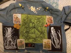 a jean jacket with patches and pictures on it