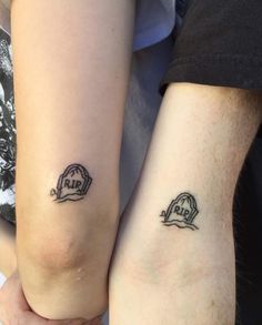 two people with matching tattoos on their arms